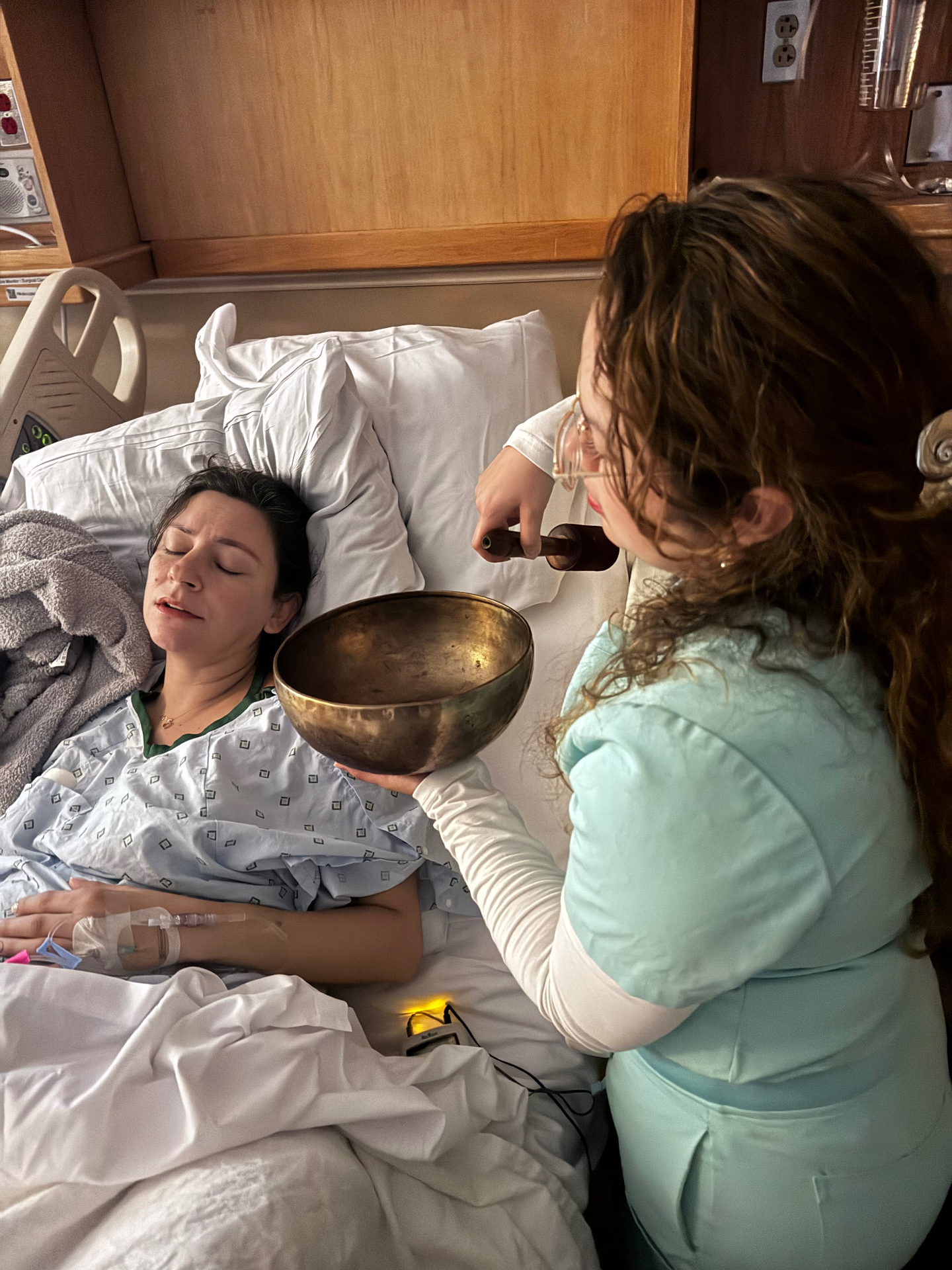 A doula offering sound therapy during early labor